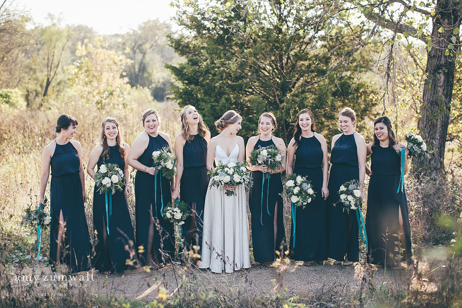 Bridesmaids in navy blue dresses at Trinity River Audubon Center in Dallas TX