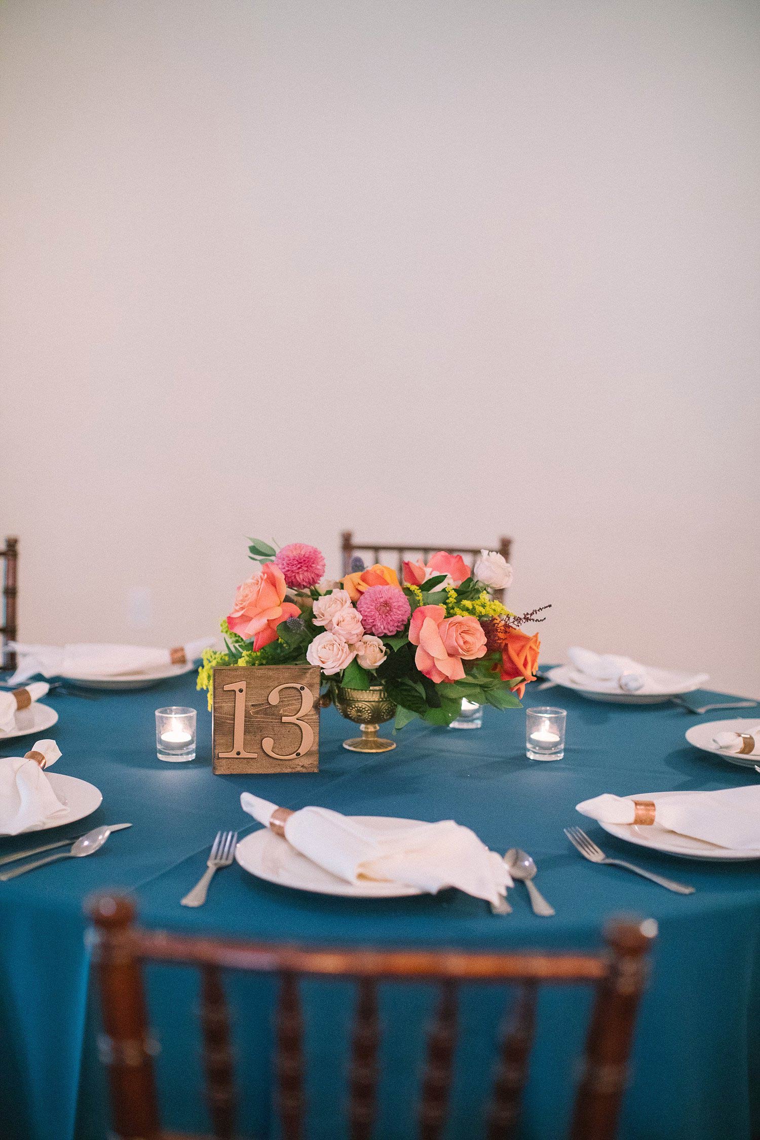 Colorful flower centerpiece with a wood table number