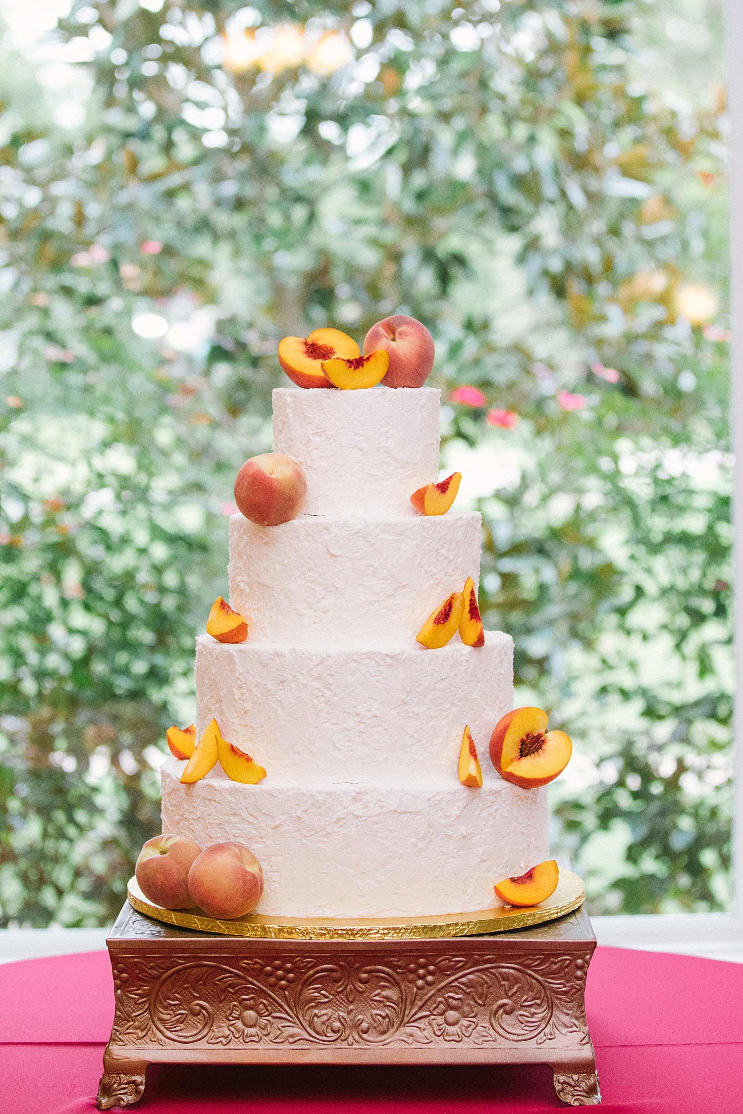 Wedding cake with peaches on copper cake stand
