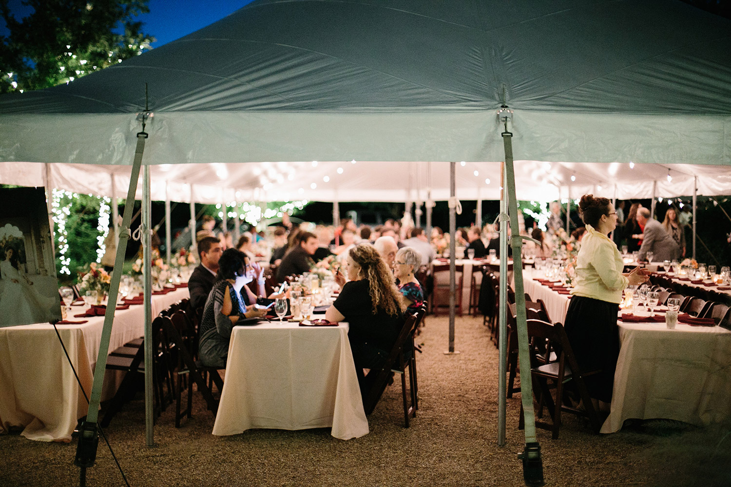 Texas tented wedding at night with hanging cafe lights
