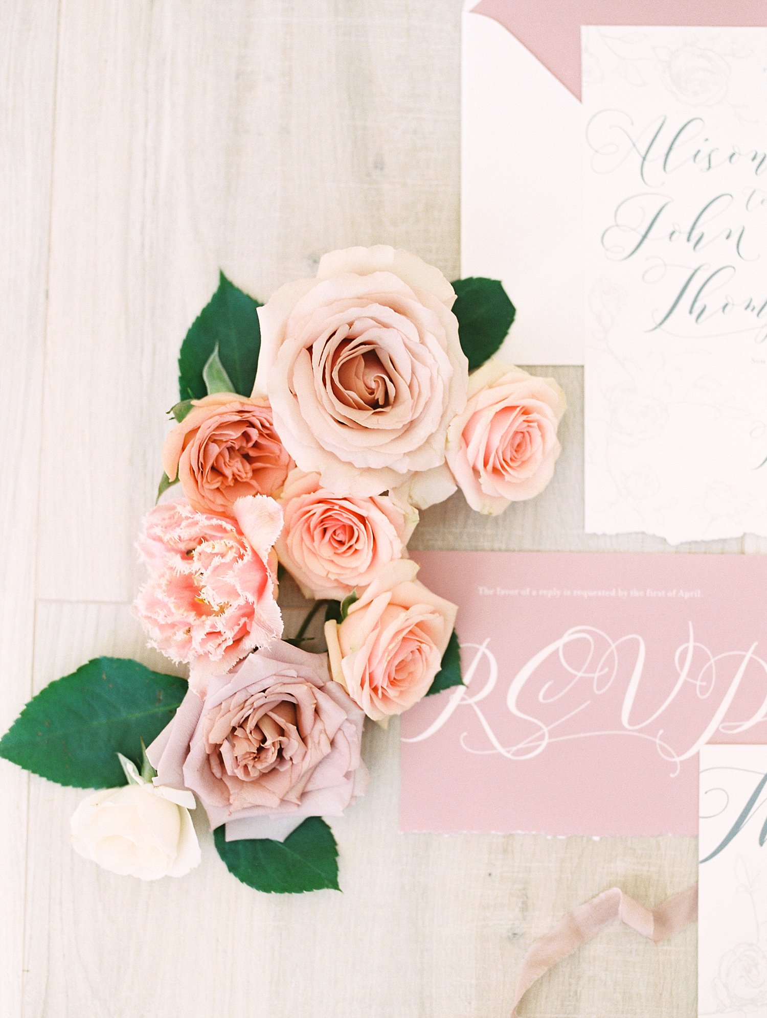 Roses next to a pink RSVP card