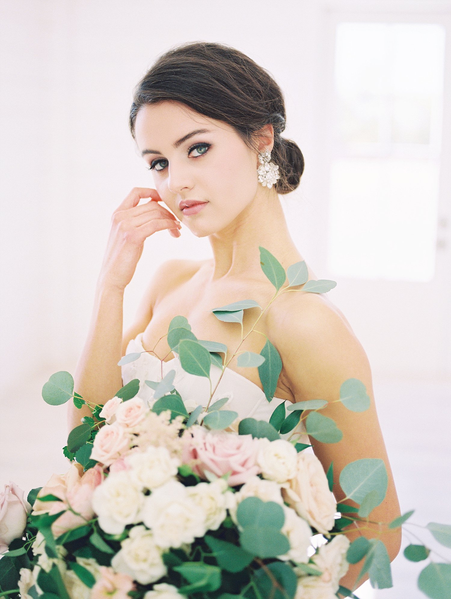 Bride with southern updo holding organic bouquet