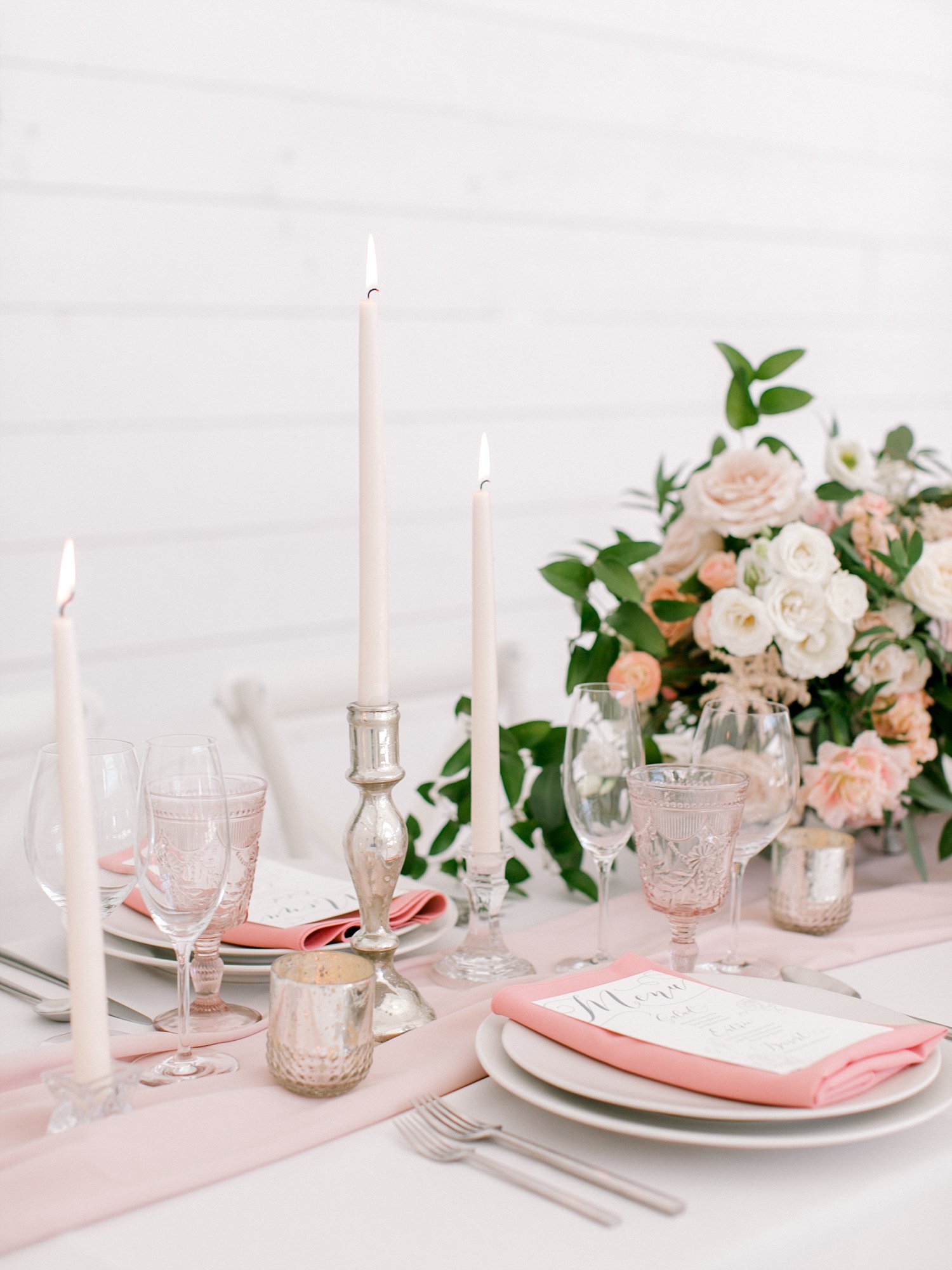 mauve napkin and a blush table runner on a white linen