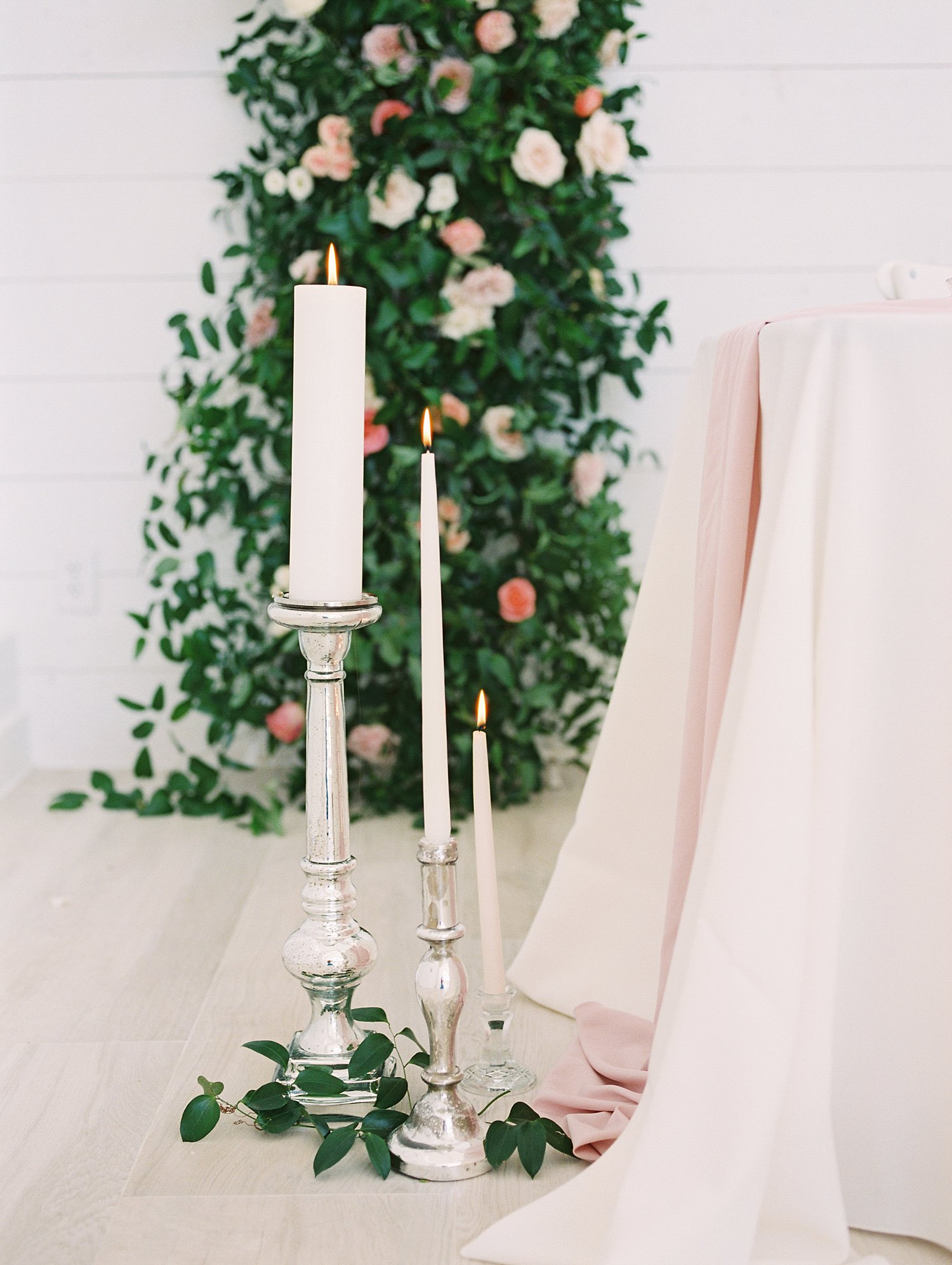 white tapered candles with silver candle sticks