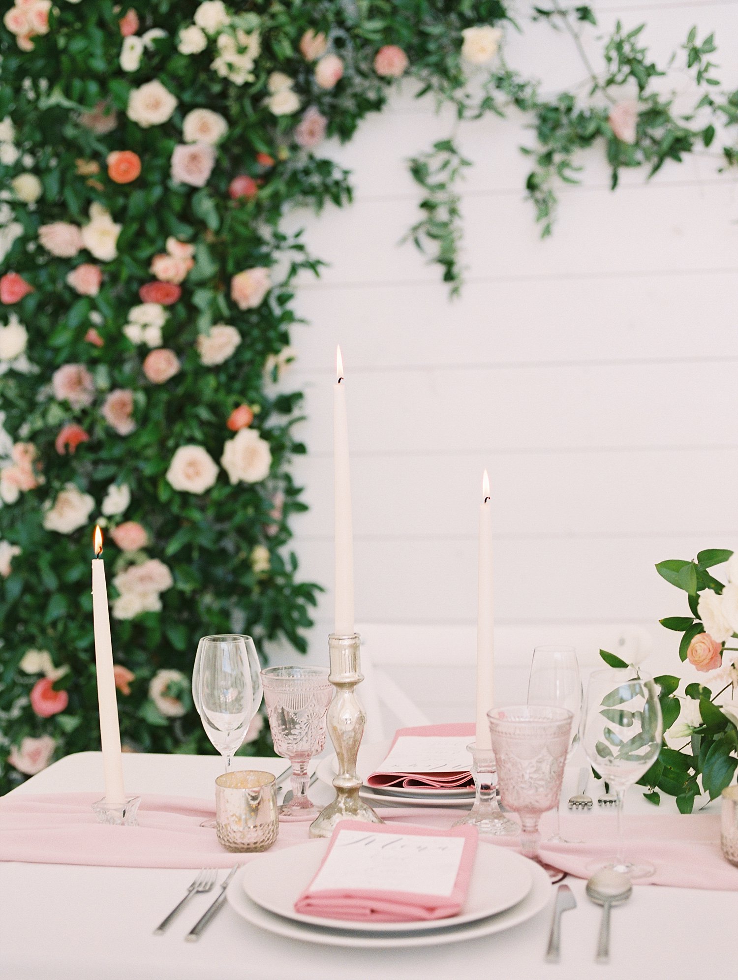 greenery and rose backdrop with a elegant tablescape