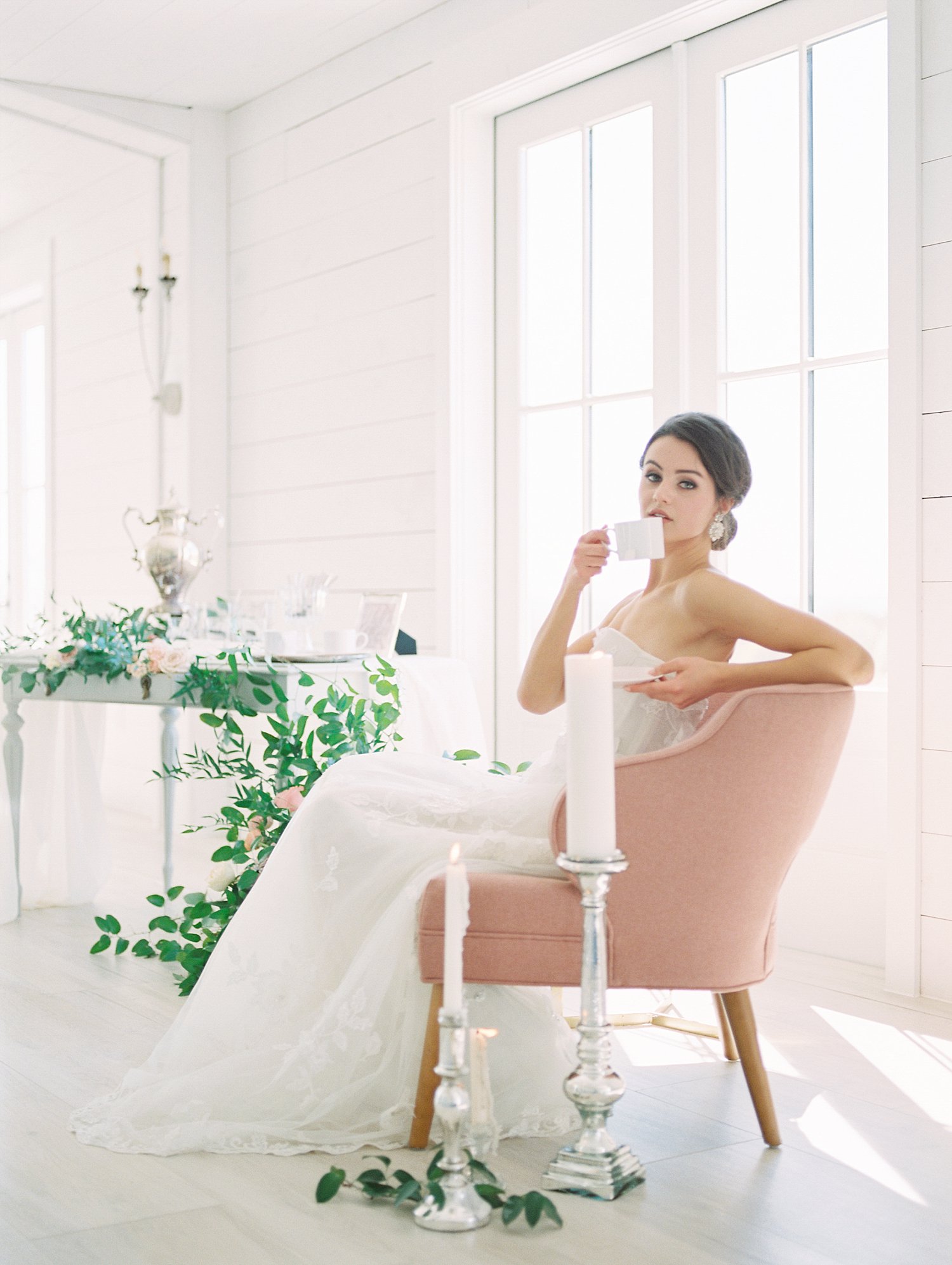 bride sitting in a pink chair drinking tea