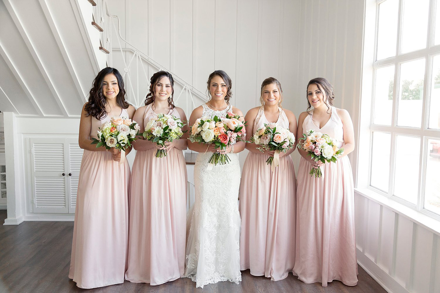 Blush bridesmaid dress with peach and pink bouquets