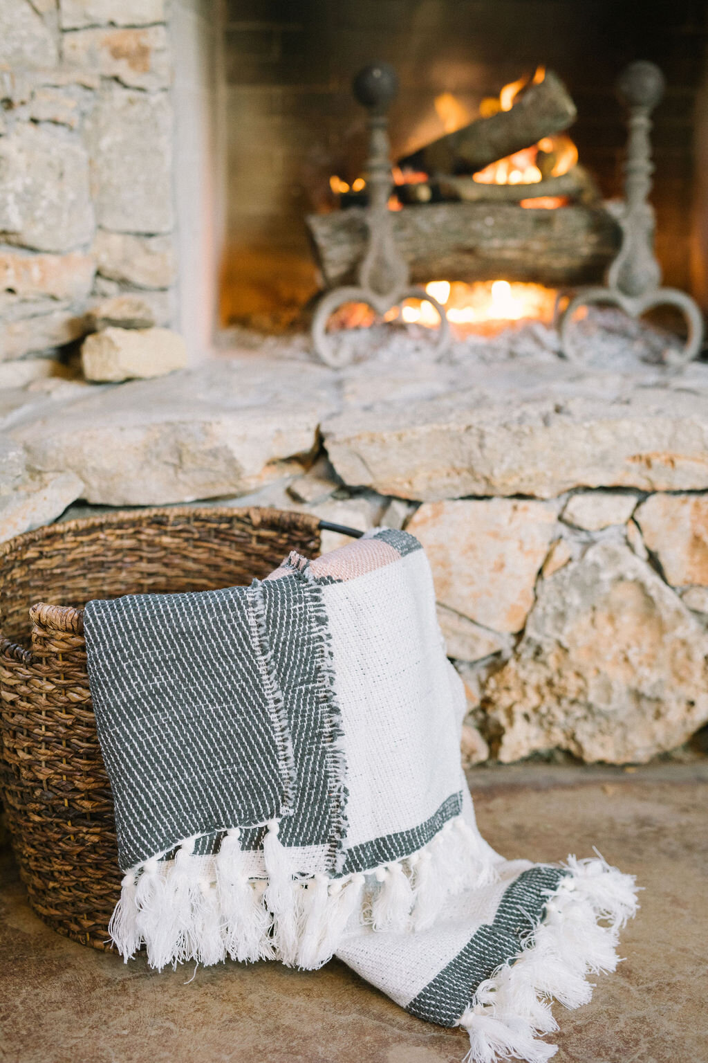 Blanket basket for outdoor seating area next to the fireplace