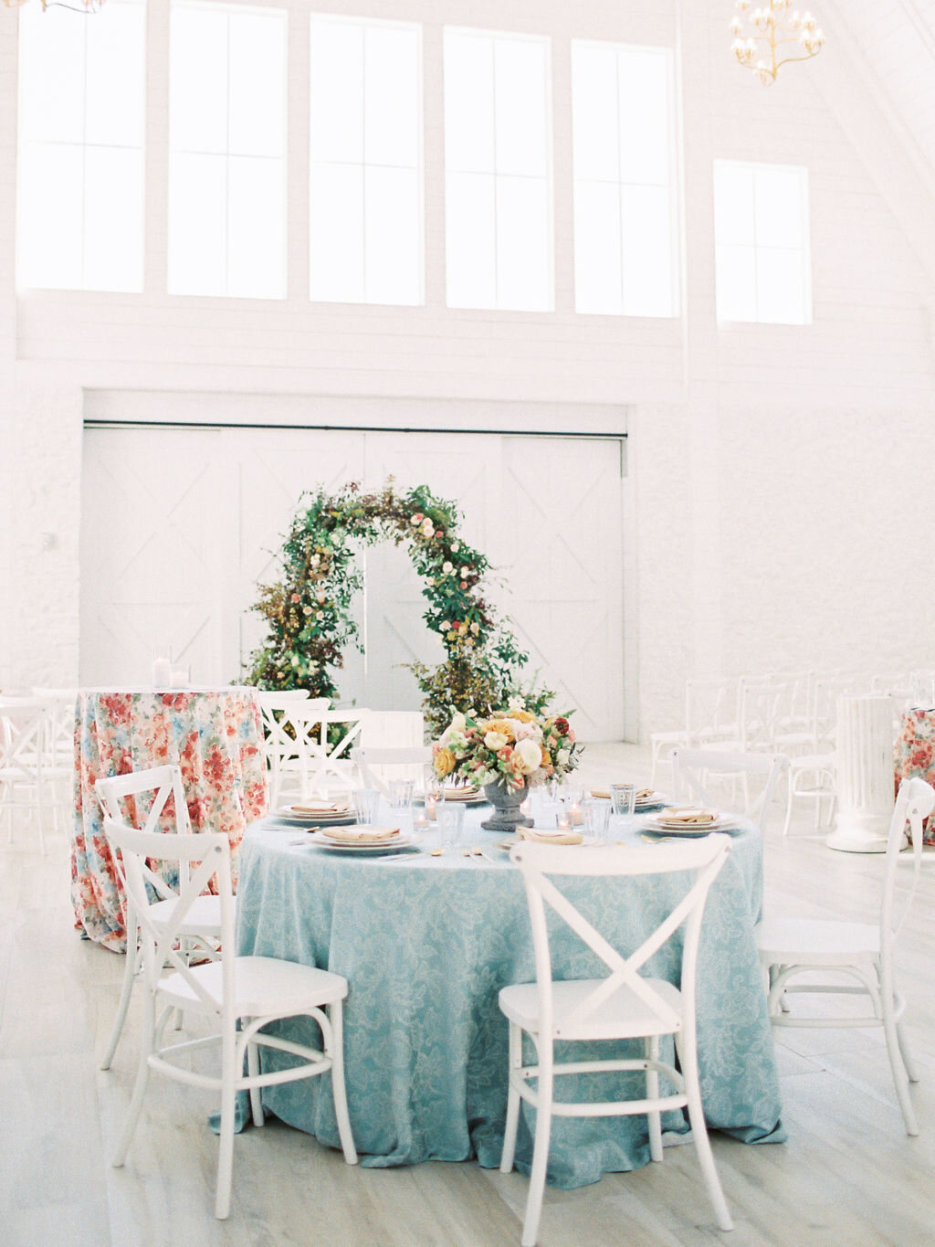 The Nest at Ruth Farms wedding reception with light blue linens &amp; colorful cocktail tables