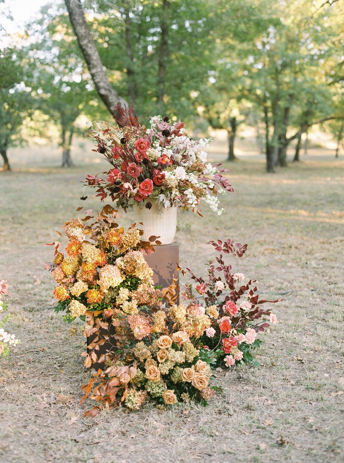 Ceremony with potted flowers on wood pedestals