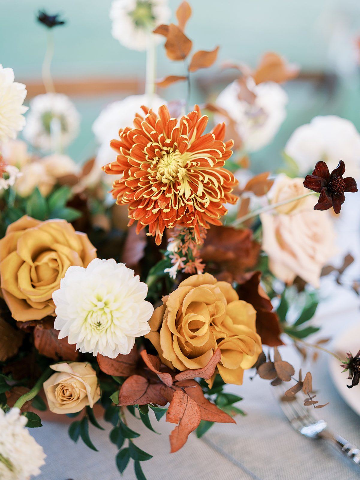 Orange and red wedding flowers at outdoor tented wedding by Shannon Rose Events