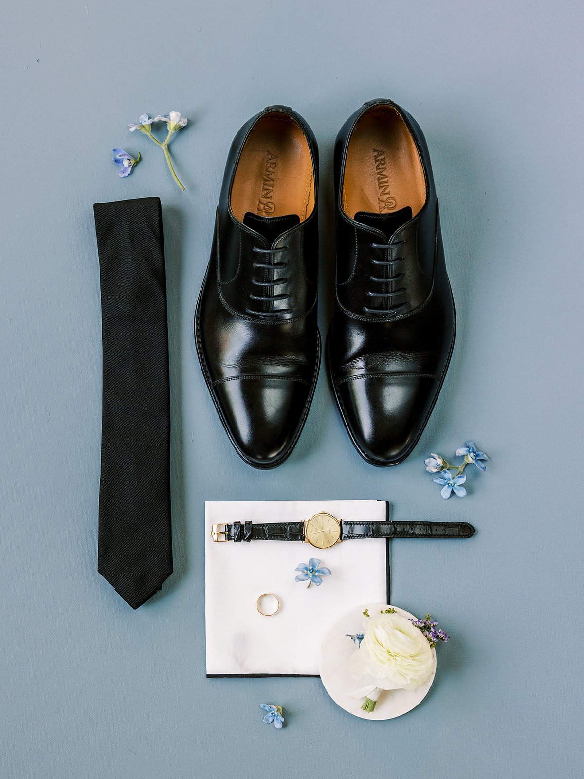 Groomsmen details styled by Shannon rose events on a blue backdrop