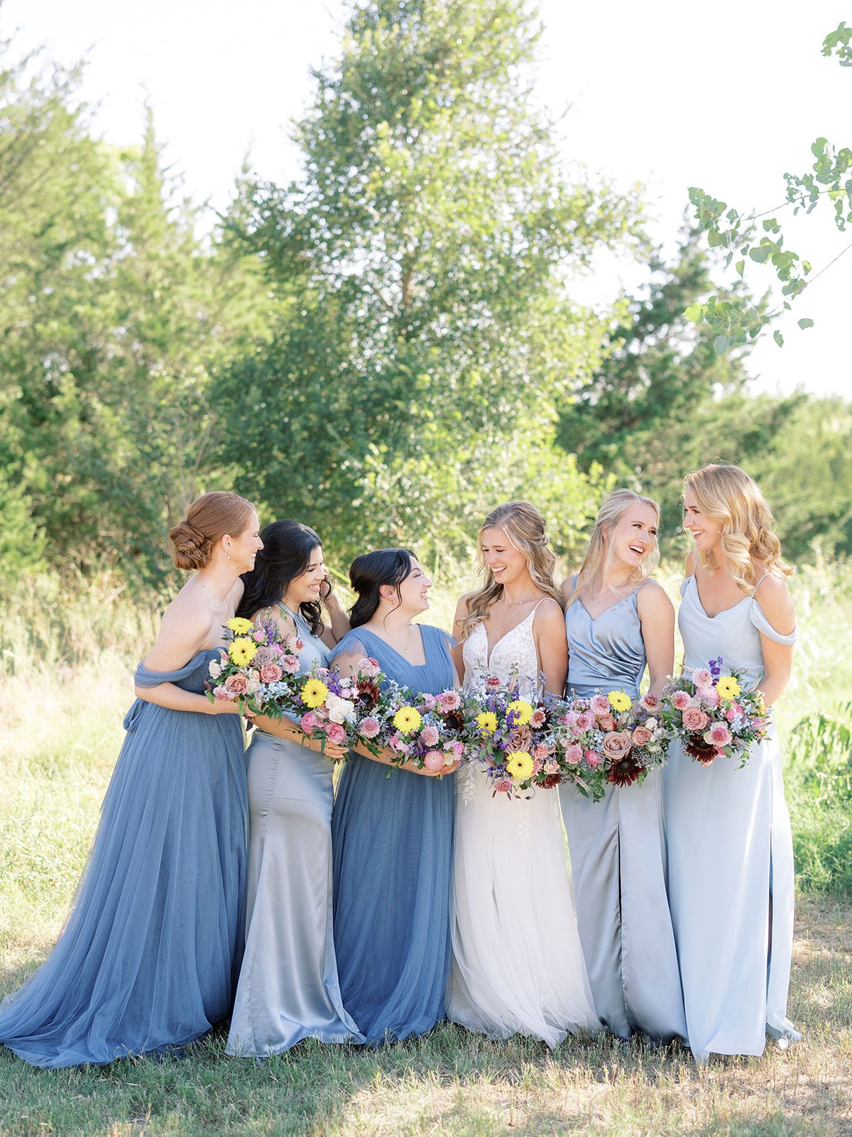 Blue bridesmaid dresses with colorful wildflower flowers