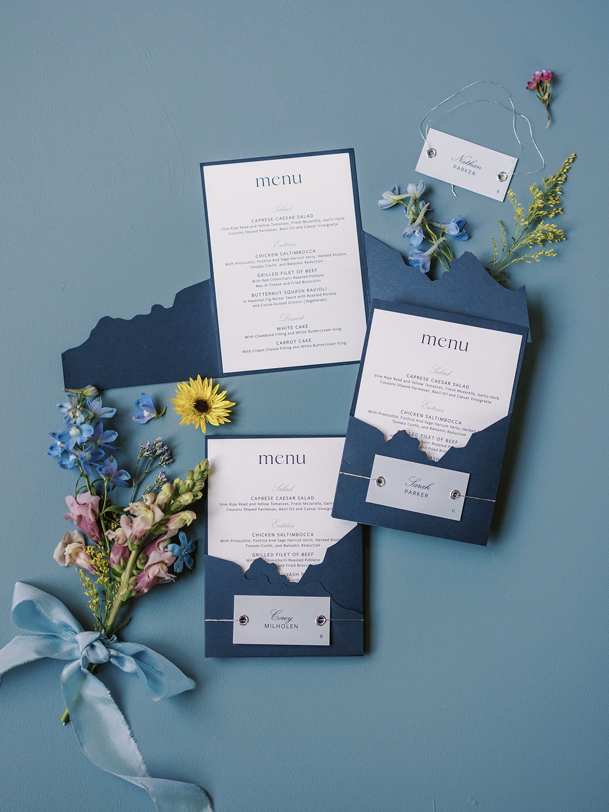 Mountain blue wedding menus with light blue escort cards