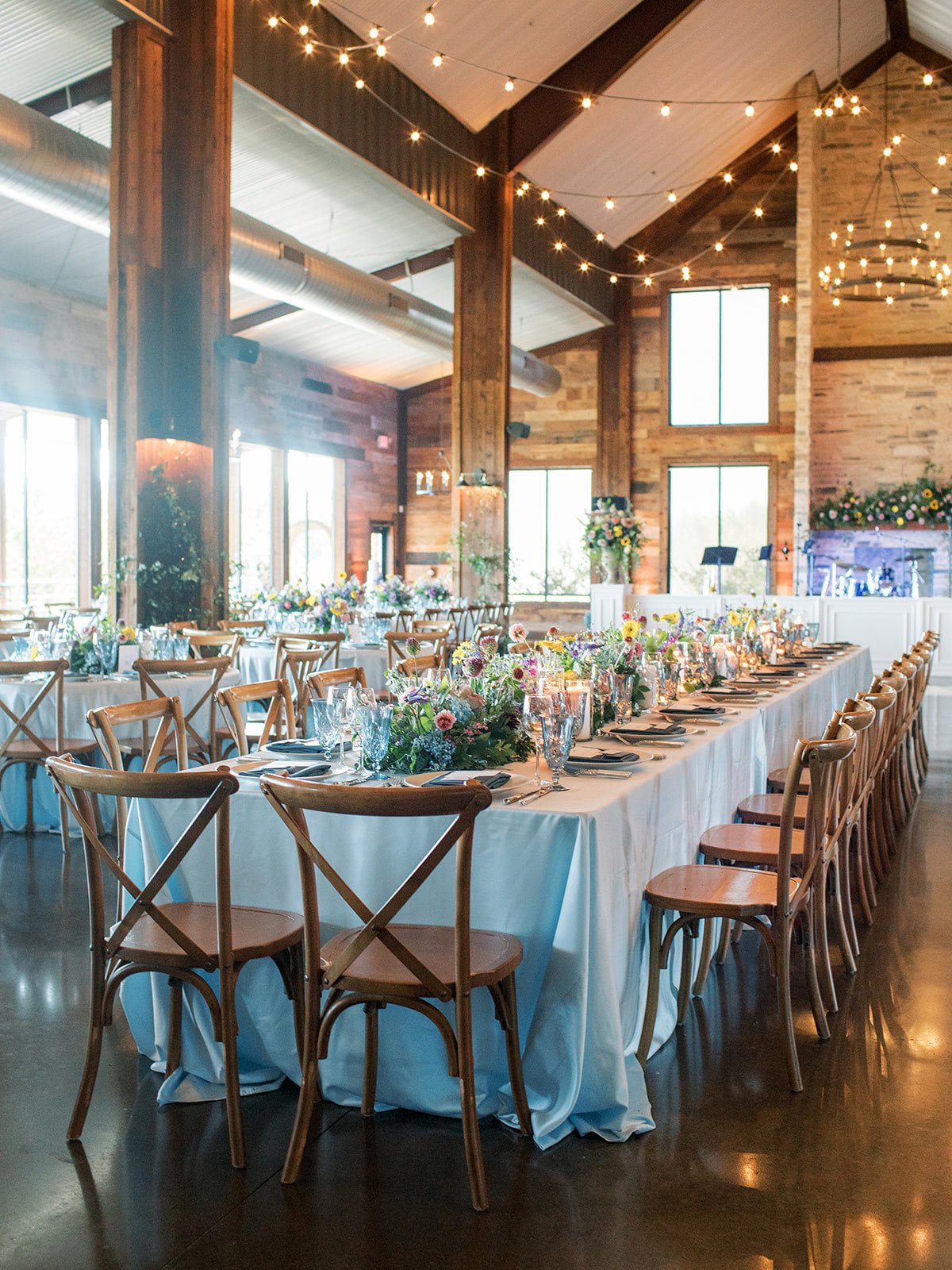 Stone Crest Venue wedding reception with light blue linen by Texas Ranch wedding planner Shannon rose events