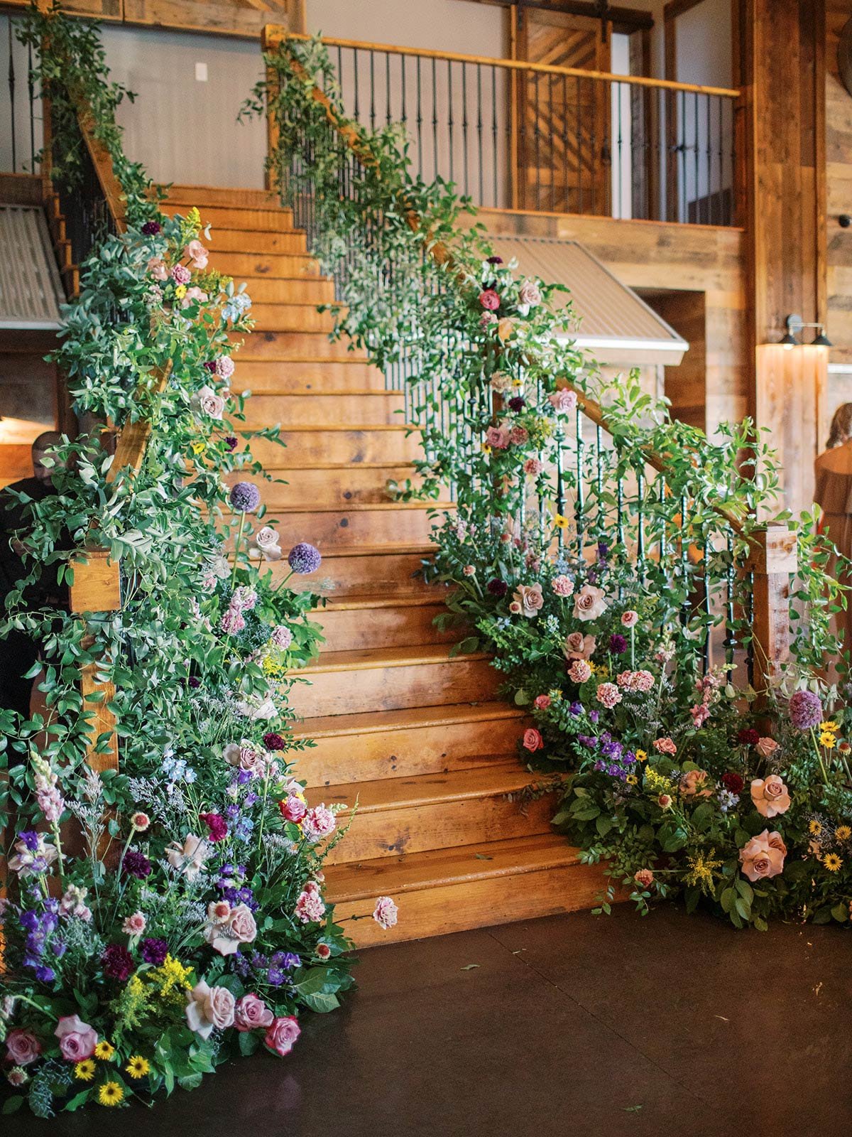 Wedding Stairs with organic blue purple yellow pink wedding flowers Texas wedding planners