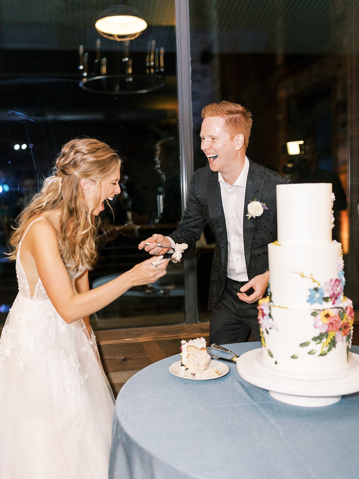 Bride and groom eating wedding cake 