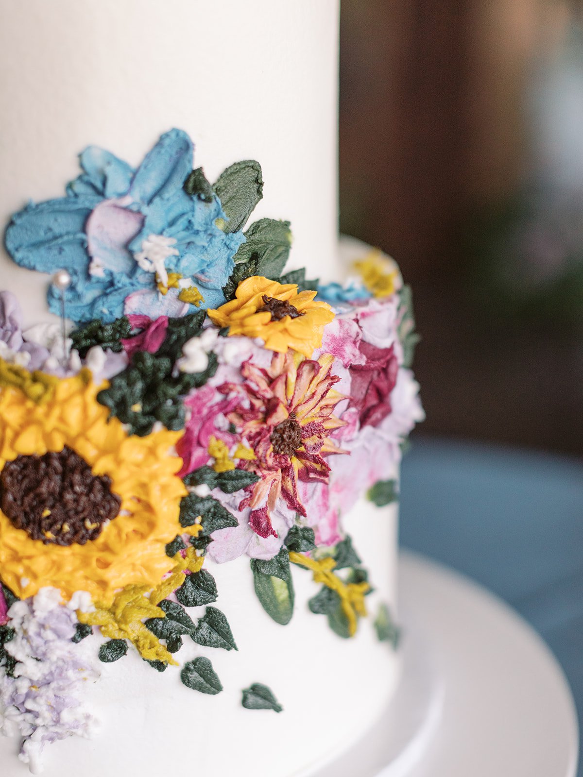 blue yellow pink and purple wildflower wedding cake