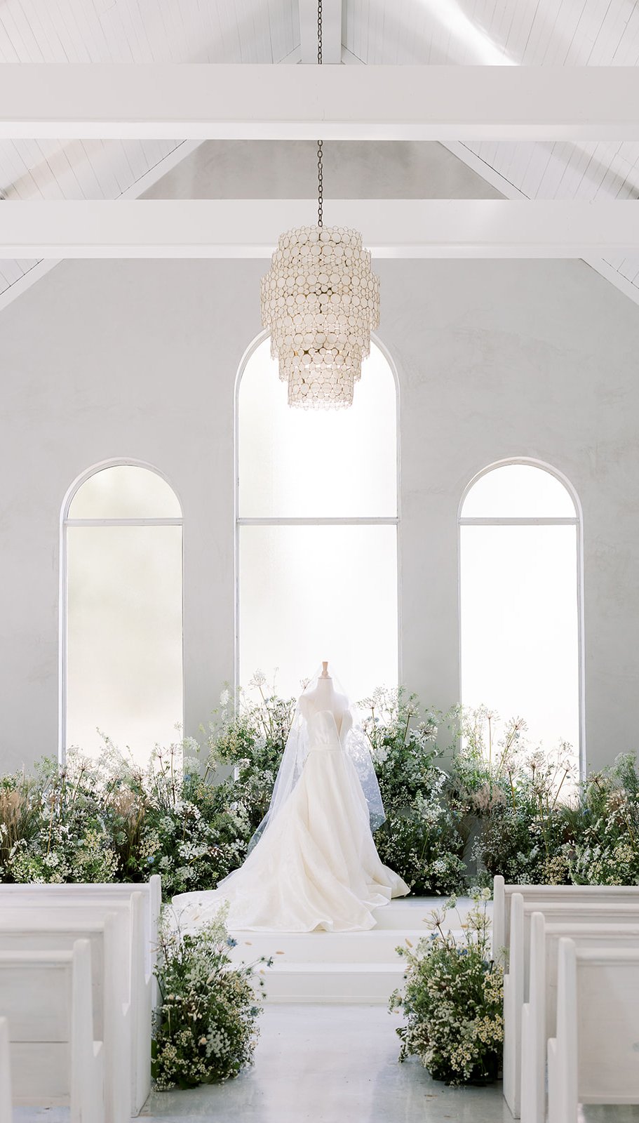 Elegant wedding dress in a field of babies breath