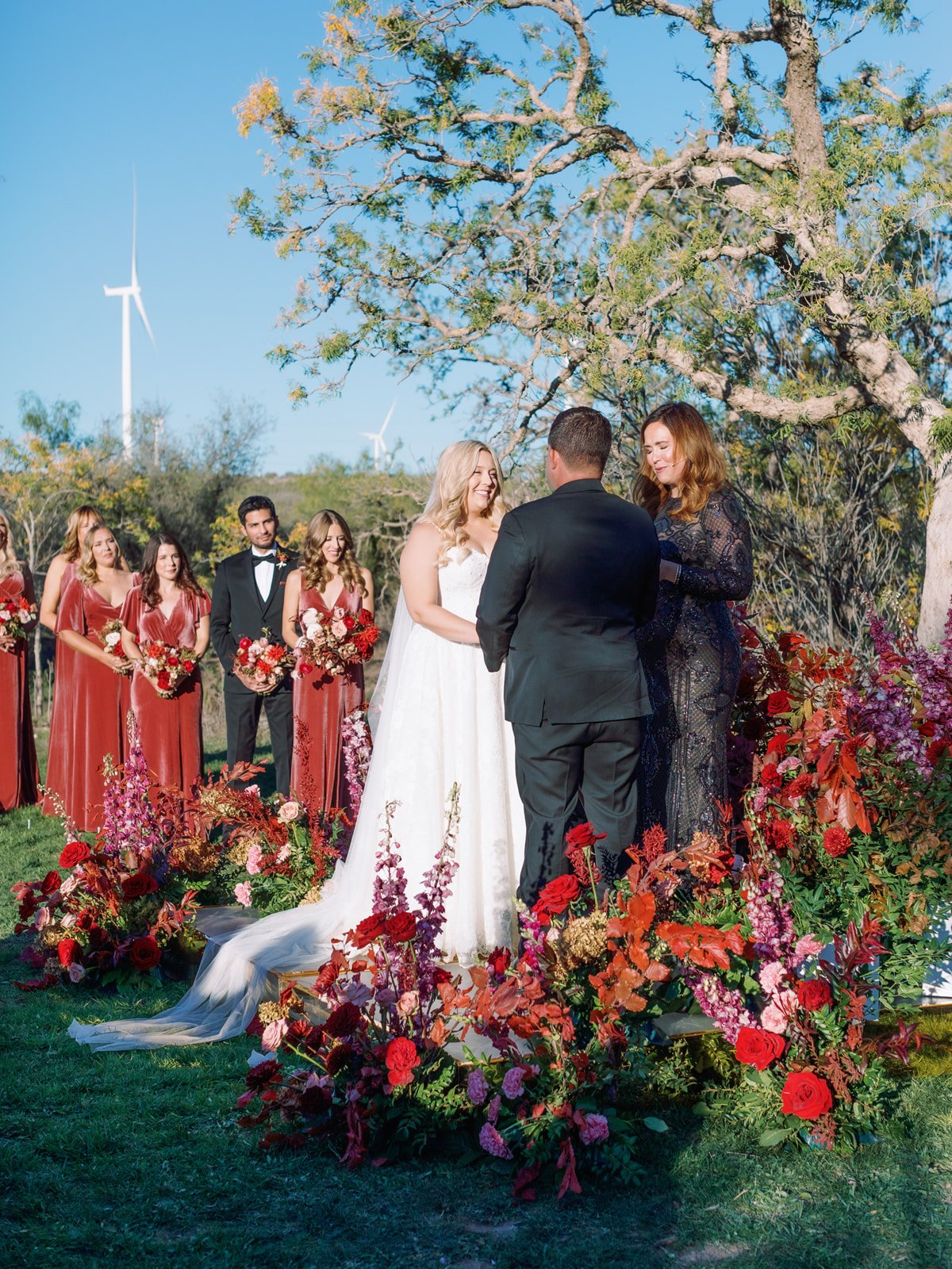 Outdoor wedding ceremony with a red halo flowers at Texas wedding