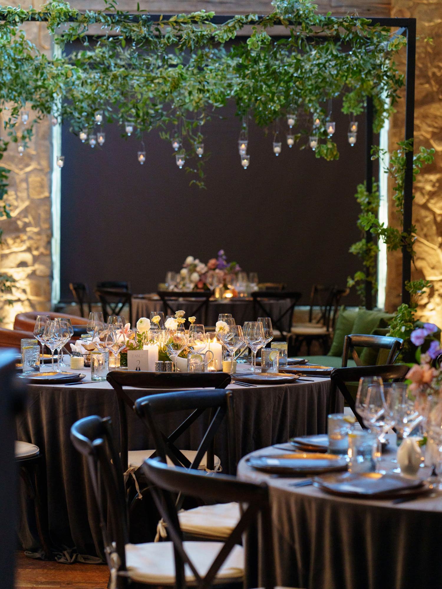 Black chairs and hanging greenery at the Hotel Drover reception designed by Shannon Rose Events