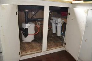 The water treatment systems (reverse osmosis units) are installed beneath each resident's sink, providing clean water for drinking and cooking through an additional spigot