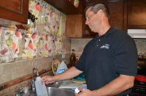 Mark Abbott of Riverside County DEH collecting a drinking water sample for Babcock Labs in a rural Coachella community mobile home park