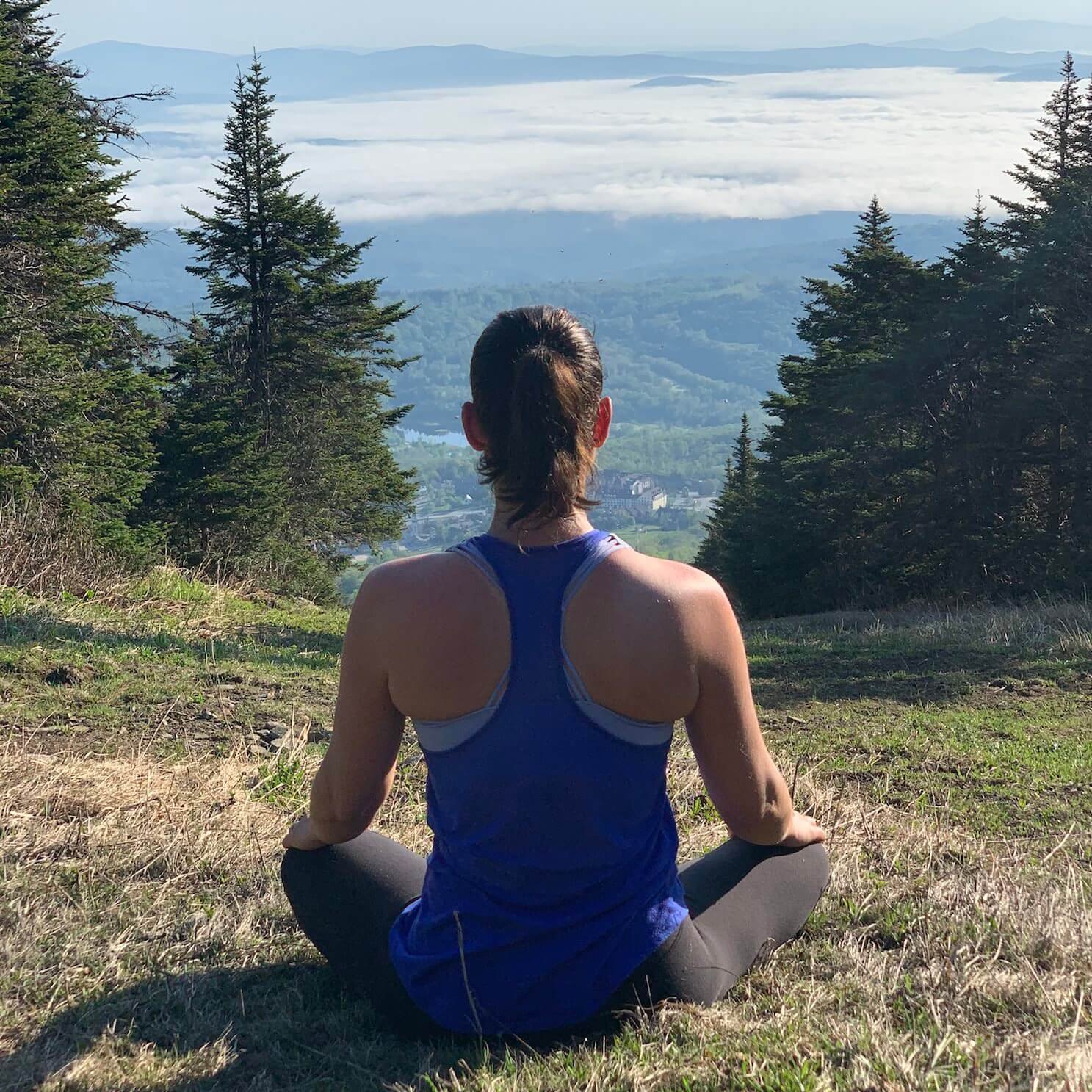 larissa sitting on a hill overlooking mountains.JPG