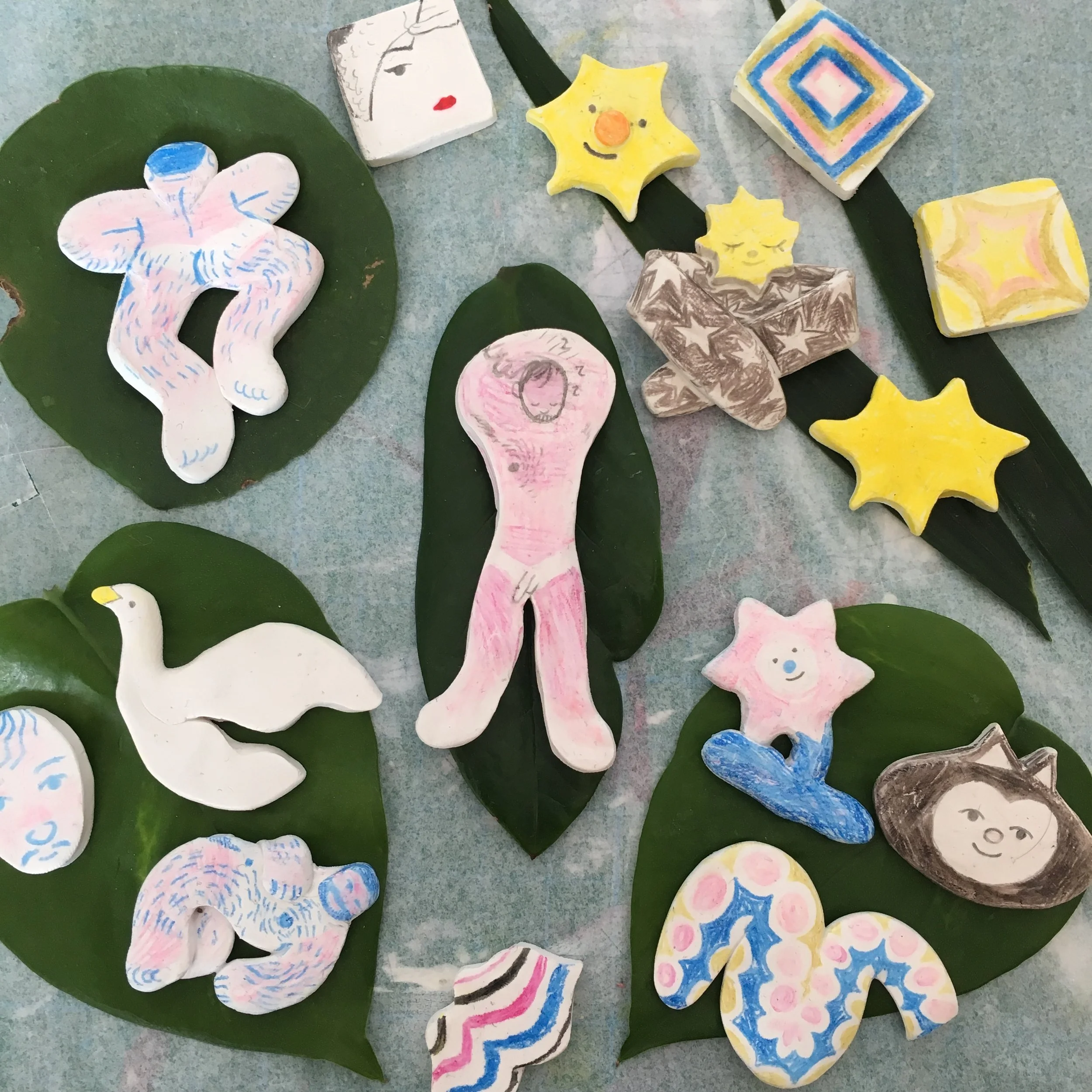small oven-bake clay pins, drawn over with pencil crayon (2018)