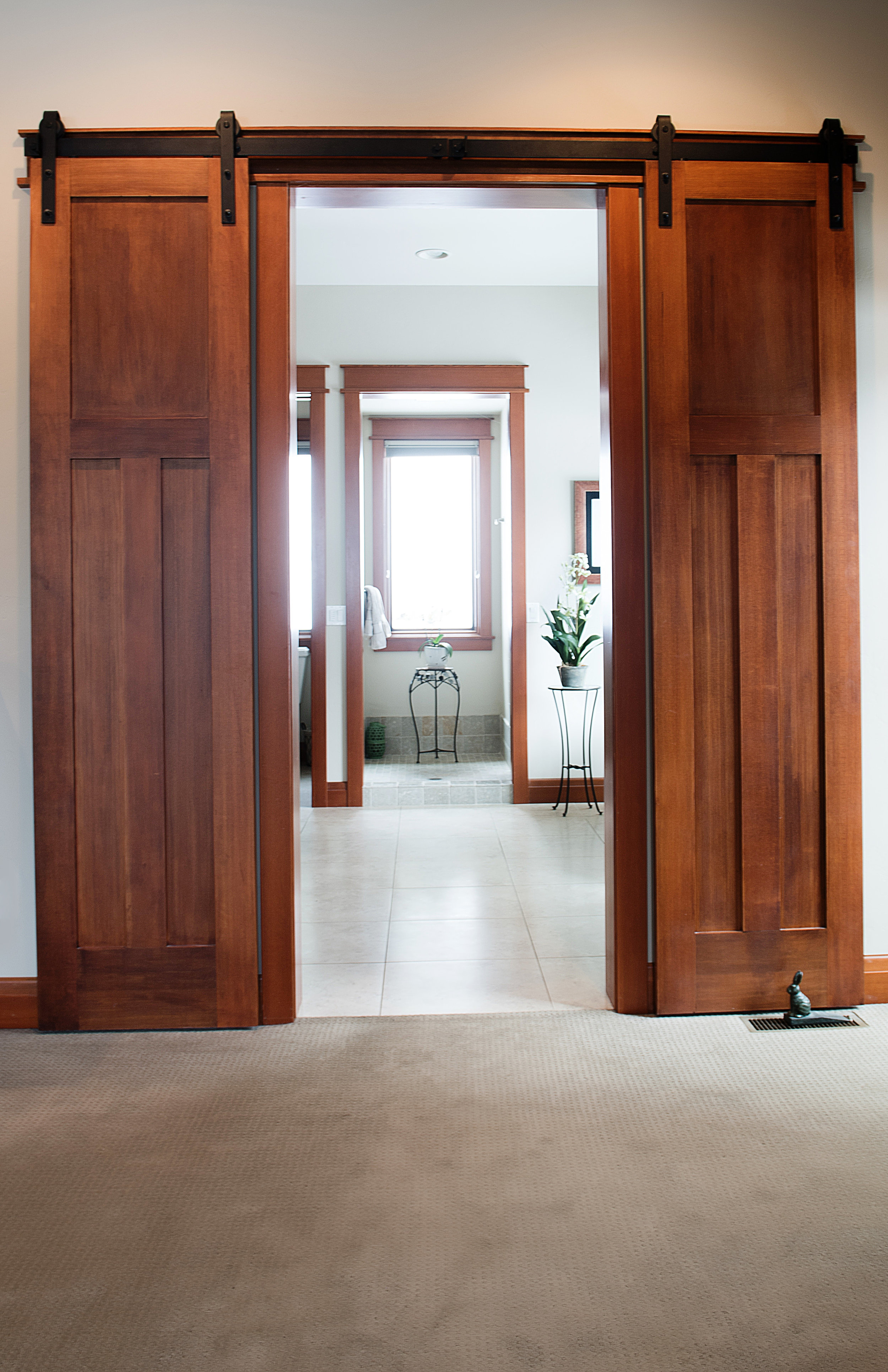 A detail shot of some rolling bathroom doors we created for a custom build in Big Fork, Montana. We love adding our custom woodwork to new home builds. 