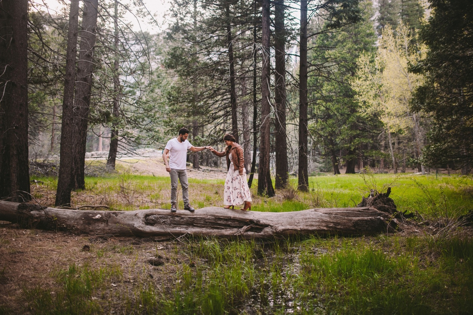 Couple Walking Over Log in Yosemite