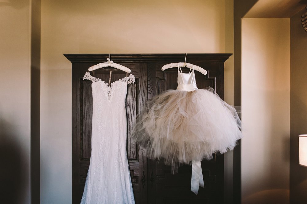 Maggie Sorreto Shae Wedding Dress & Flower Girl Dress Hanging