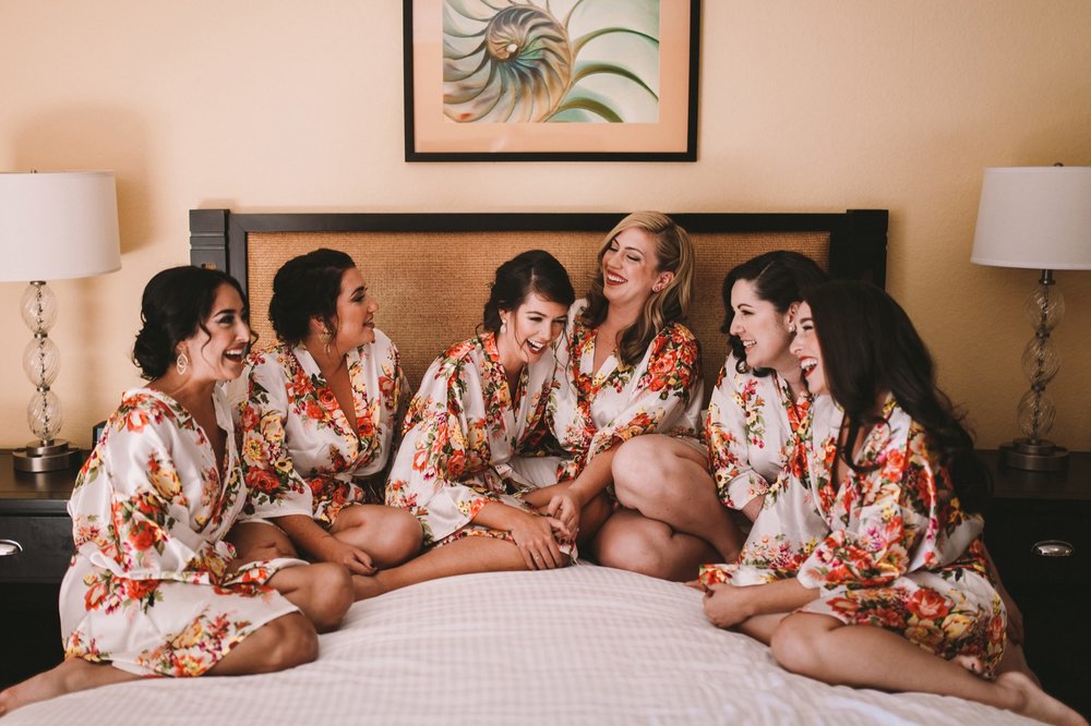 Bridesmaids in Robes Sitting Together on a Bed in Carlsbad Inn