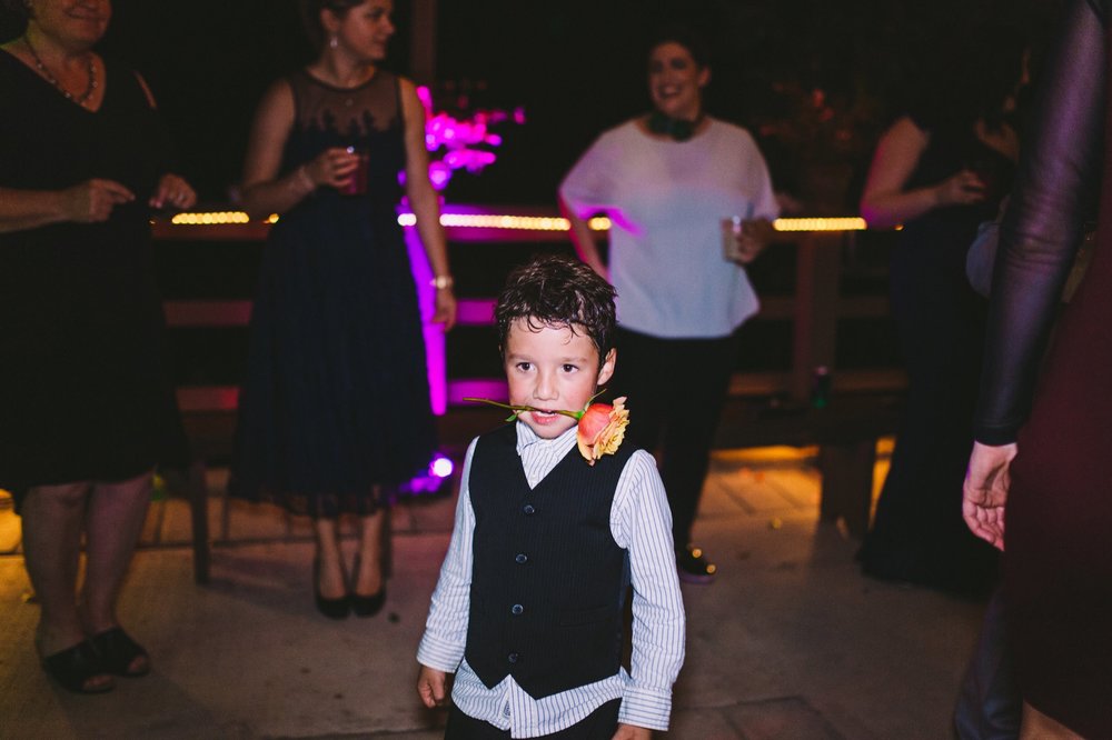 Cute Kid Dancing with Rose in Mouth at Wedding