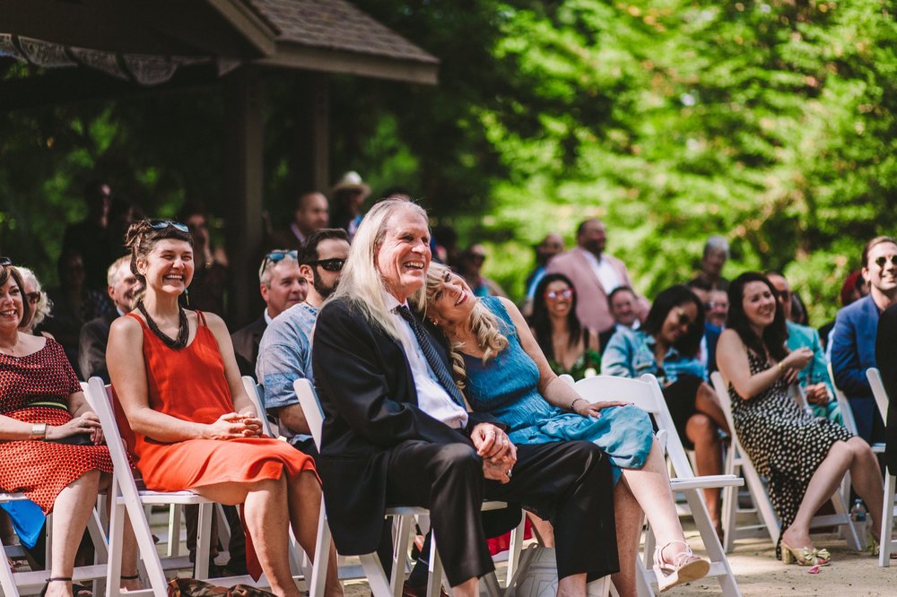 Photograph of Guests Laughing &amp; Happy During Wedding Ceremony in Sanborn County Park