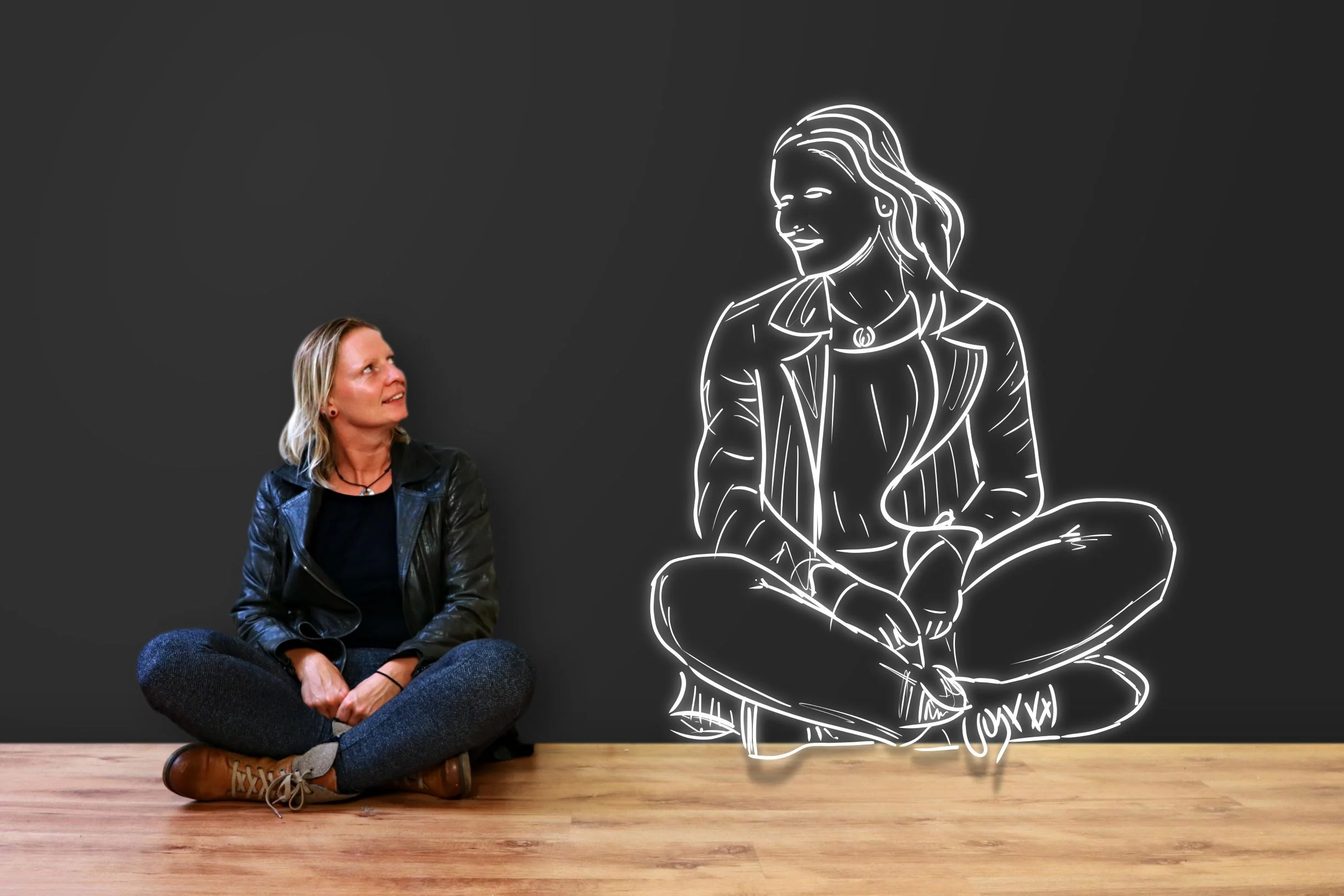 Woman looking at drawing of self.jpeg