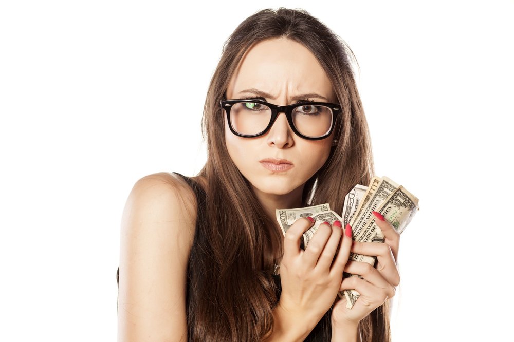 Greedy woman holding on to money.jpeg