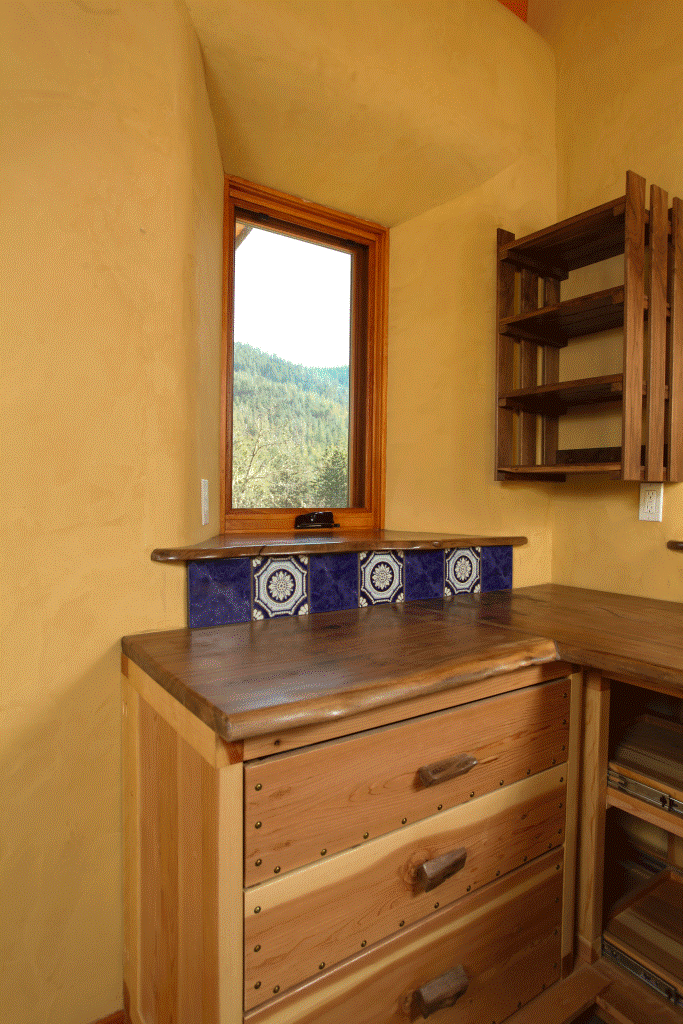  Tiled back splash reduces wear-and-tear on interior clay plaster below window. 