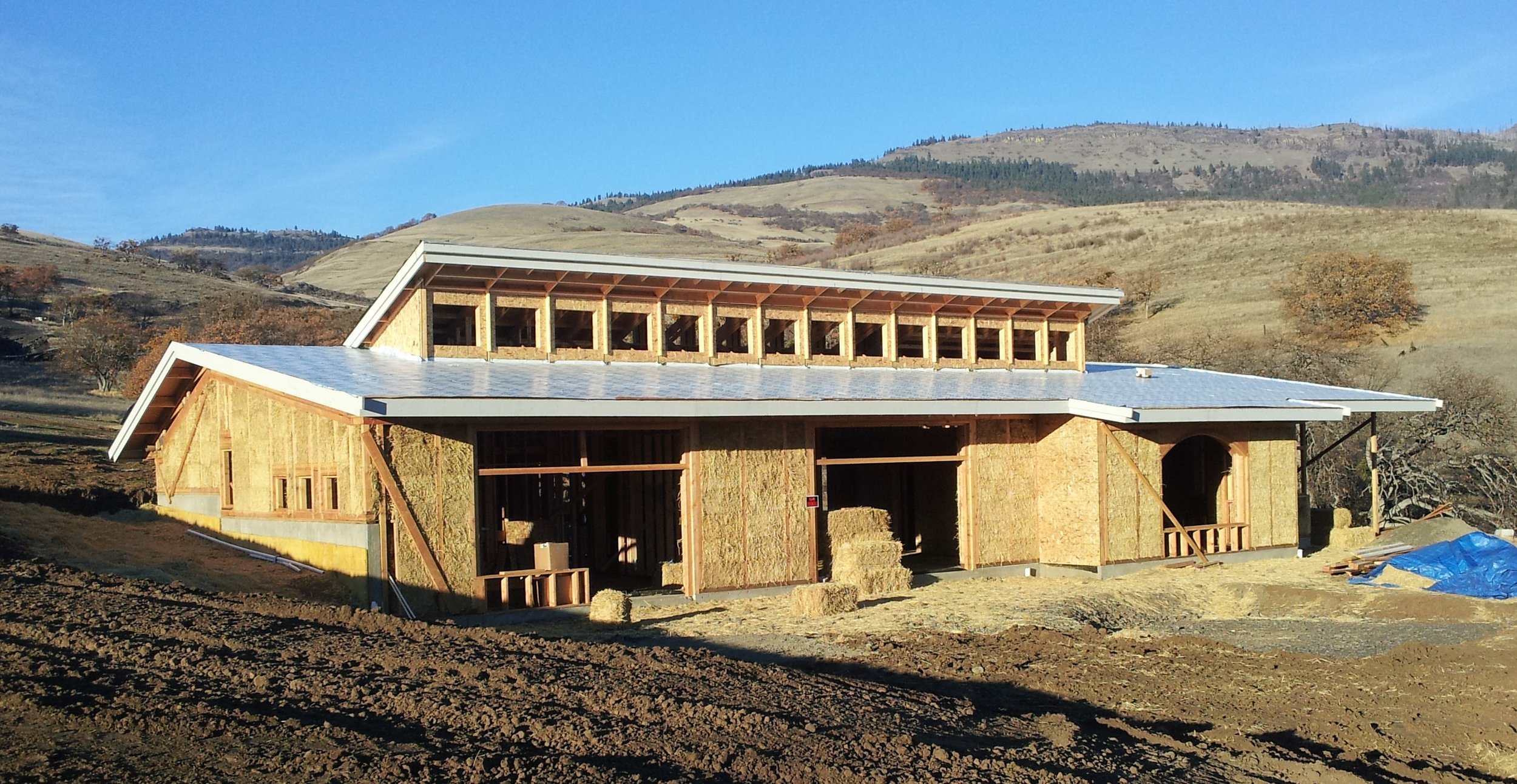  Passive solar straw bale house uses both straw bale shear wall and interior partition shear walls. &nbsp;Lime exterior and interior plasters. 