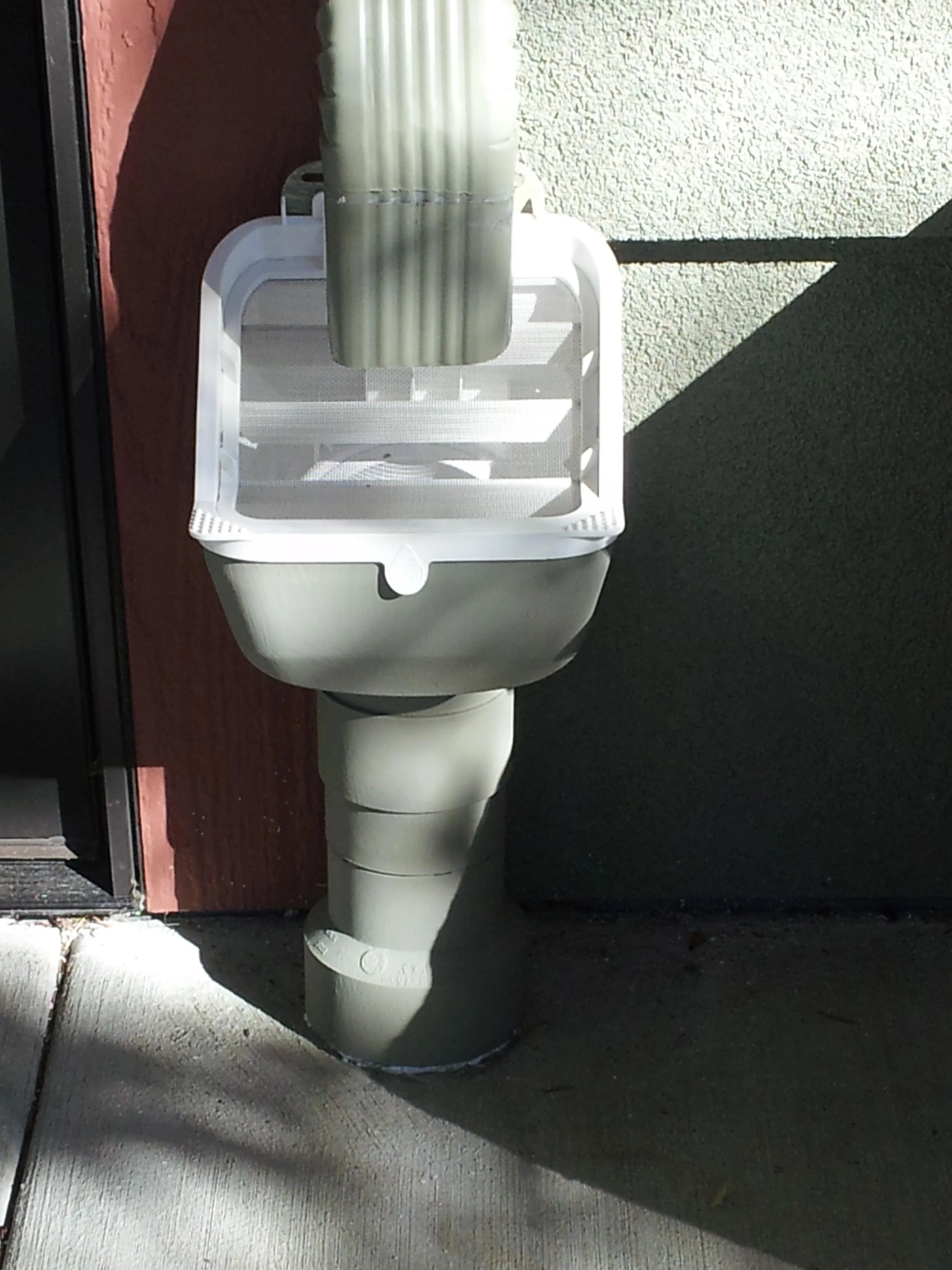 Downspout filter removes leaves, pine needles