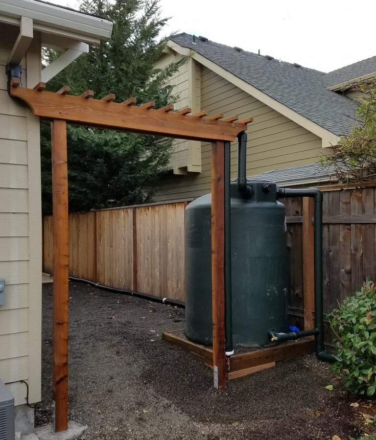  500 gallon system with gutter screens, first flush, overflow and outlet. &nbsp;Trellis carries inlet pipe, supports first flush. 