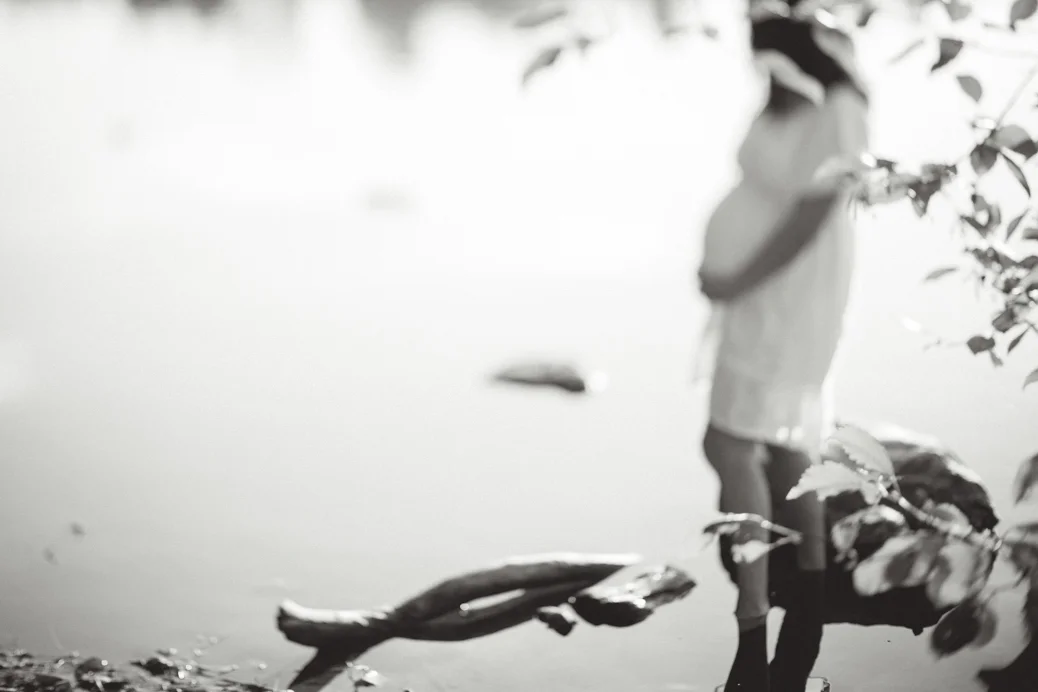 pregnant woman in white dress in water