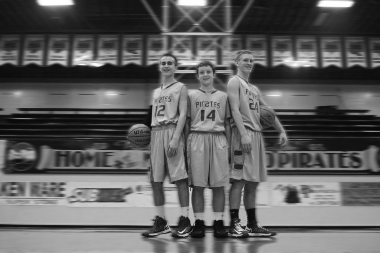 After playing basketball together for the last eight years, Justin Cooper, Jake Miles and Rylee Trendell, pictures left to right, fill big shoes by playing varsity basketball as freshman. The friends work together to help each other improve.
