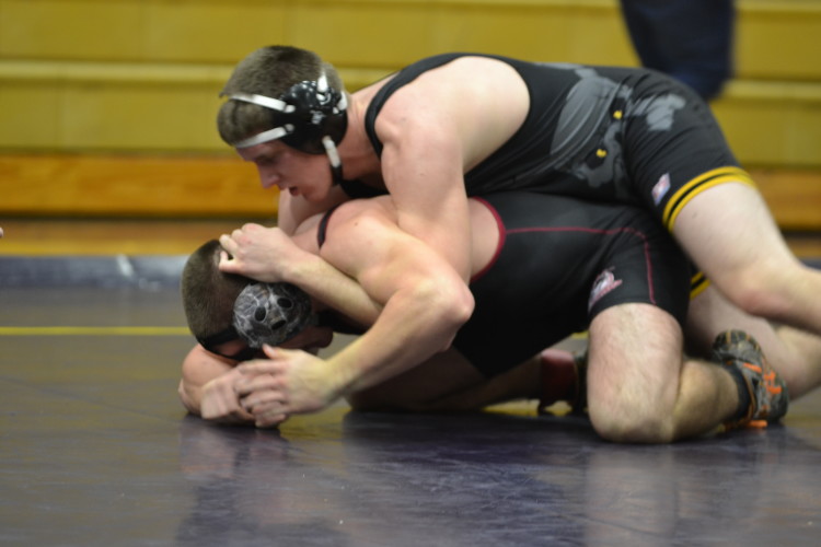Joey Vigue attempts to put his opponent in a half to pin him. Vigue won 11-3, 4 being team points.