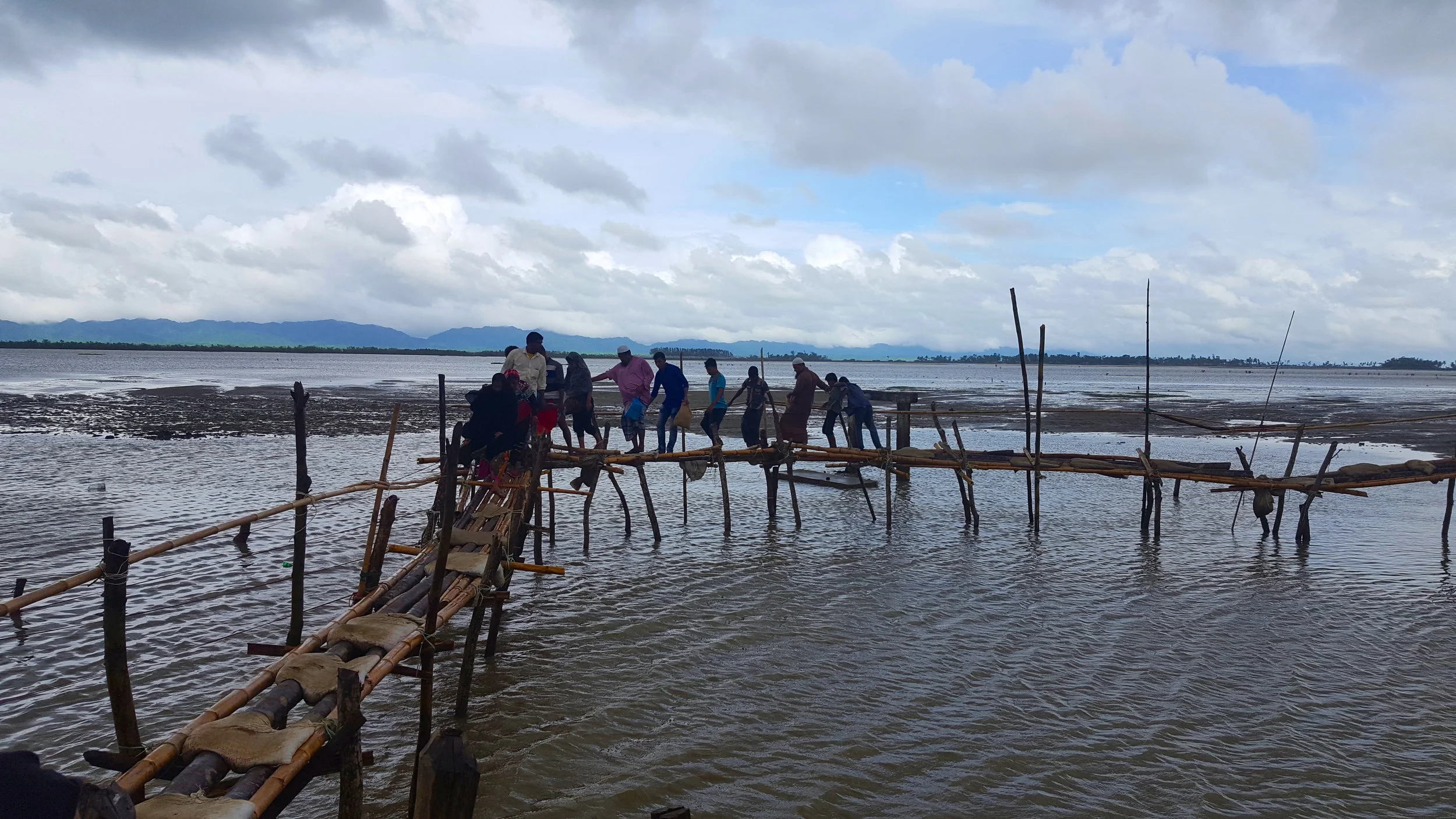 Hundreds of refugees have crossed into Bangladesh using this makeshift bamboo bridge built by Friendship, a Bangladeshi non-governmental organization. This precarious bridge has served as a replacement for the one that preceded it, which collapsed under heavy rains. The Myanmar border lies across the water.