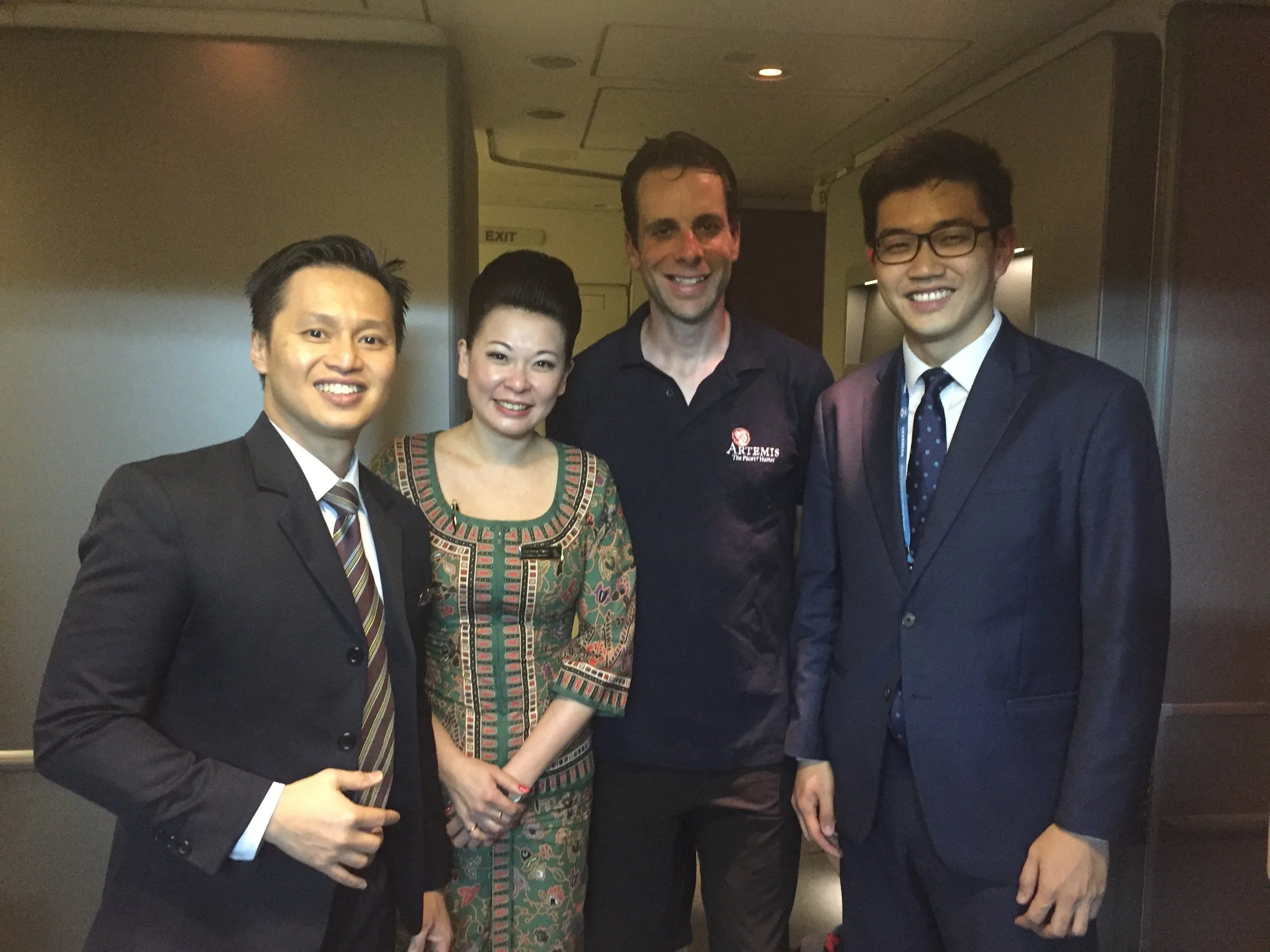Fresh faced boarding the Singapore Airlines plane with thanks to the onboard staff for looking after him and to Alex Tan for co-ordinating everything from our arrival and baggage handling (far right in the picture). 