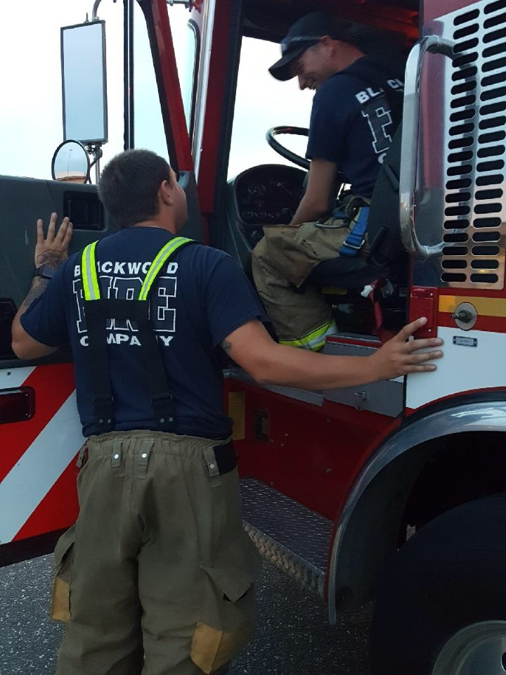 Firefighter Lemmerman conversing with Firefighter Fulcher (Driver in Training) 