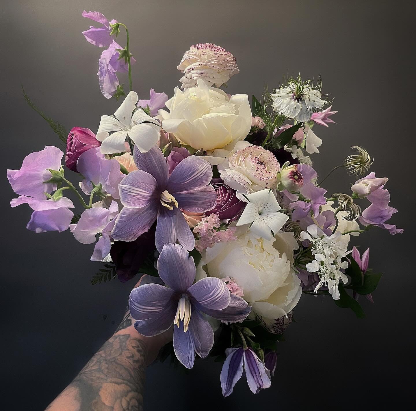Bouquet for a past bride. Working on a proposals for June! Which means going back in my camera roll and seeing what we used this past summer to jog my memory for availability. #peonies #tulips #nigella #sweetpea #clematis #ranunculus