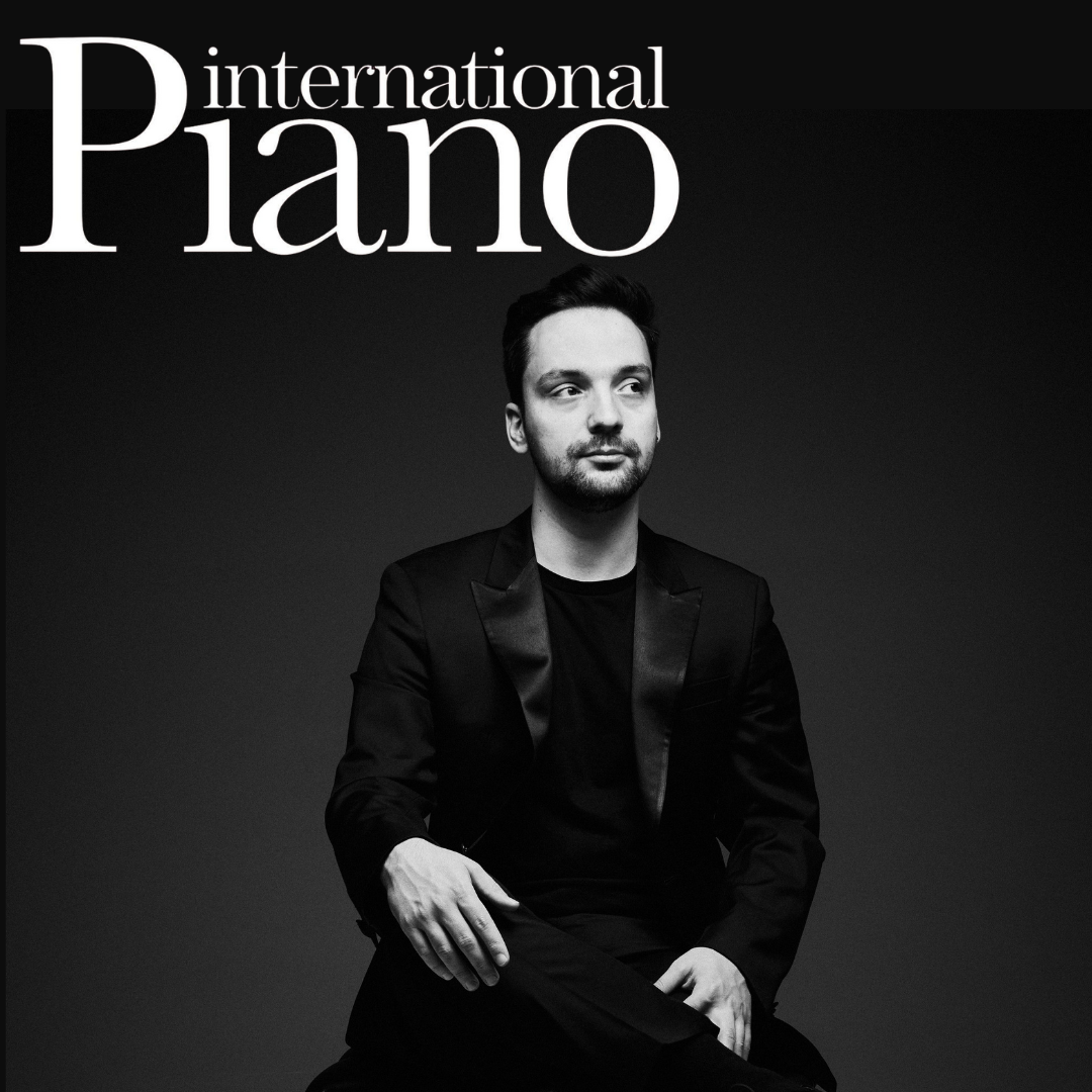 Black and white album cover featuring a man in a black suit sitting against a dark background, with the text 'International Piano' in large white letters at the top.