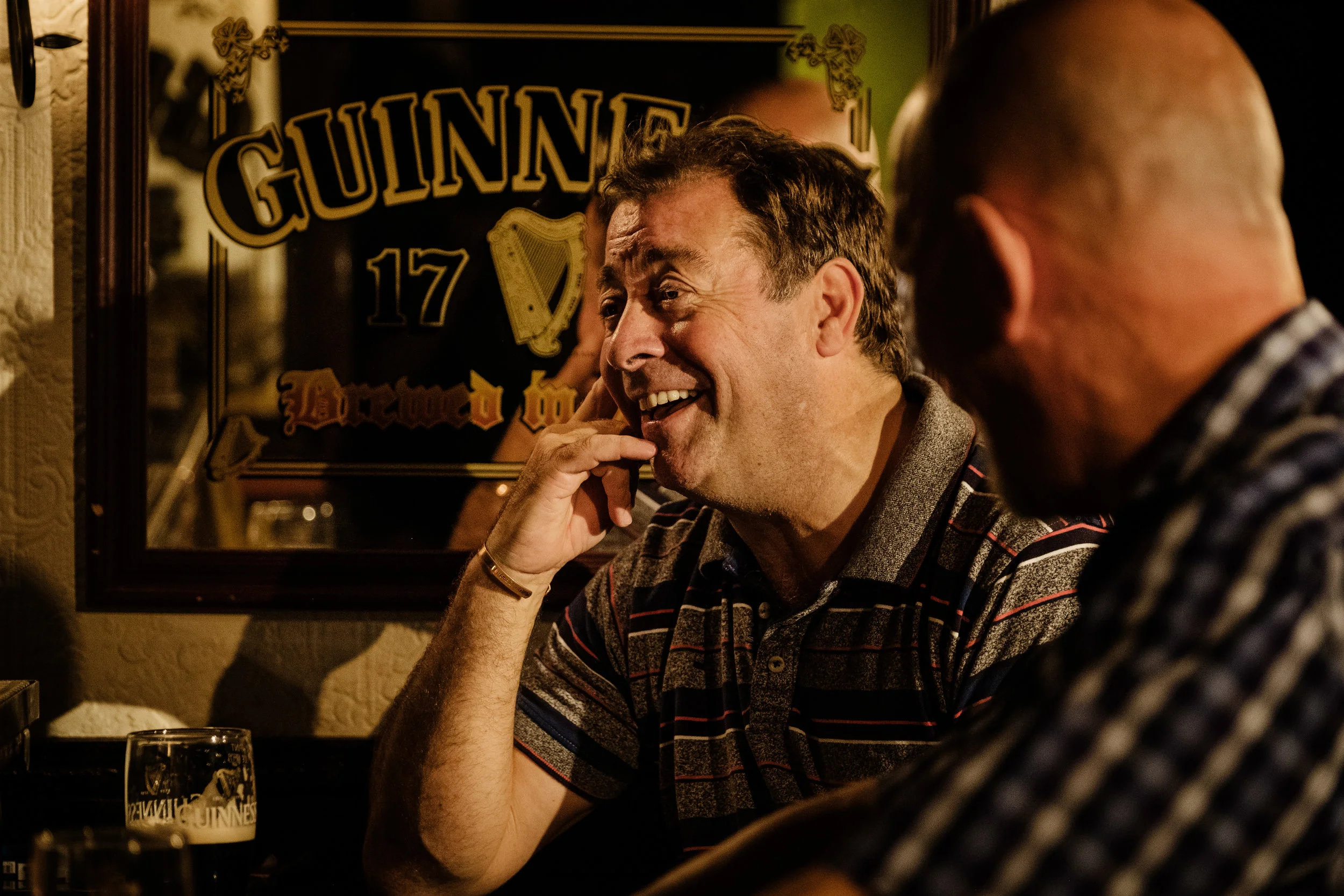 Philip Judge laughs heartily in conversation with Liam Carney in the Abbey Theatre’s Two Pints, written by Roddy Doyle. Photo by Ros Kavanagh.